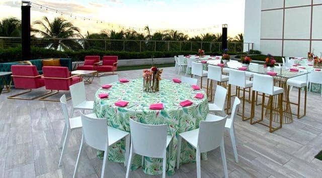 white chairs around circle tables